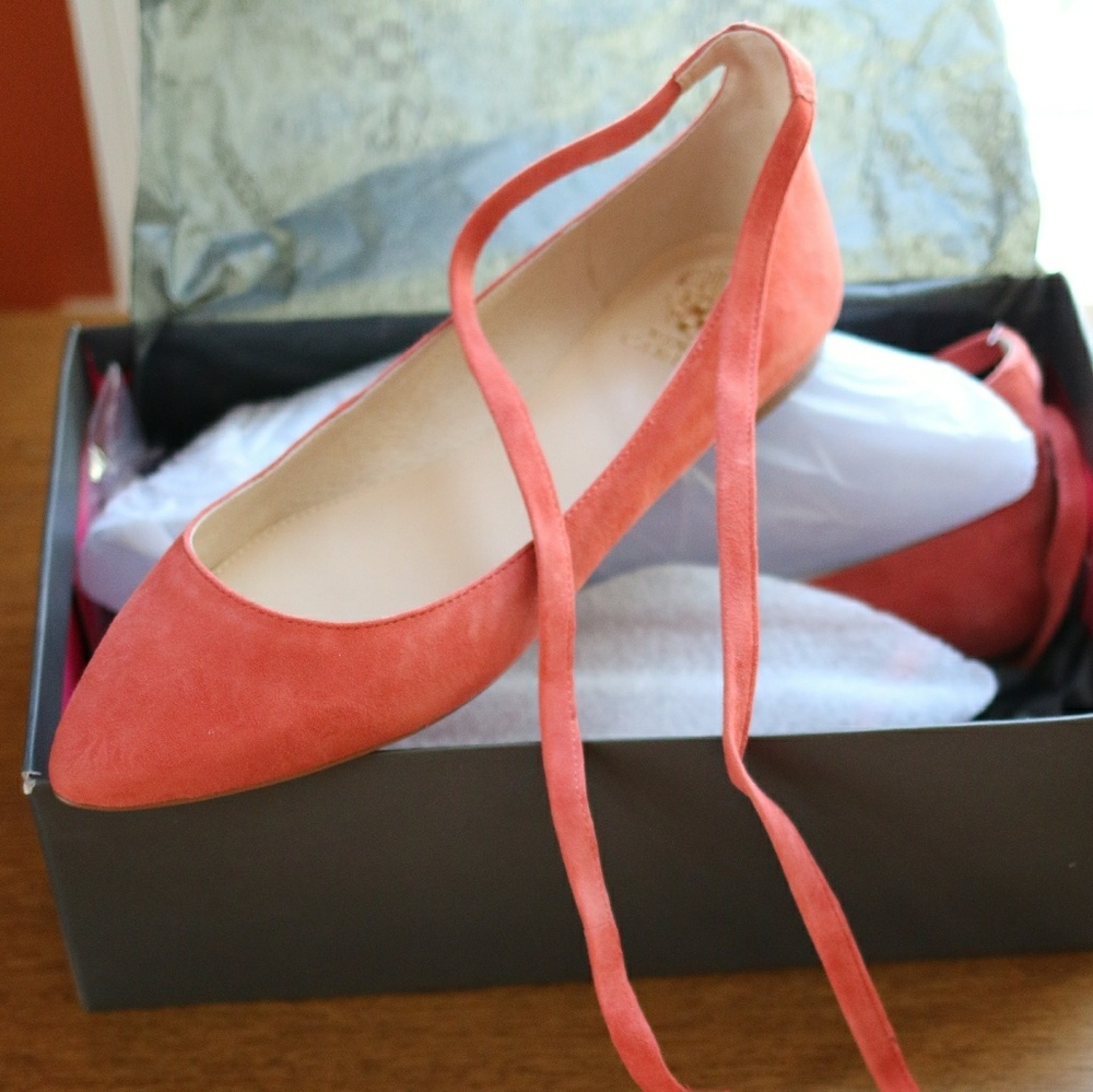 Salmon colored suede lace-up ballet flats.